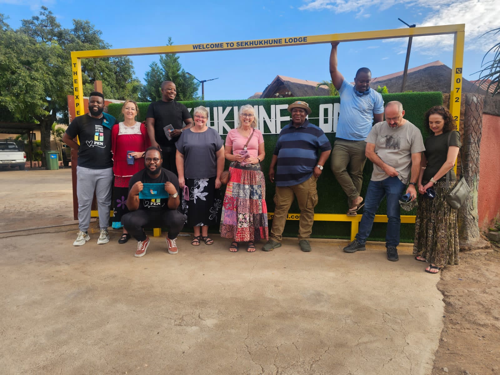 Conference group photographed at the Welcome to Sekhukhune Lodge entrance gate